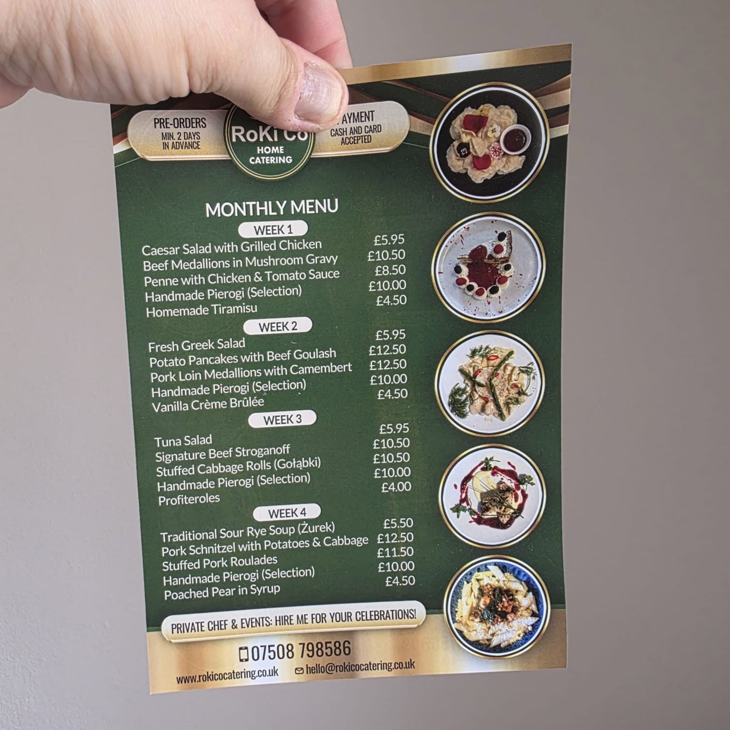 Hand holding a green A5 menu card with food items and prices on a gray background